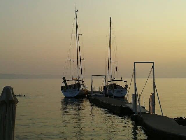 2 sailing boats at secluded cove at sunset after halkidiki sailing